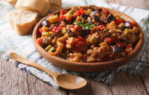 Italian appetizer Caponata close-up on a wooden plate. Horizontal